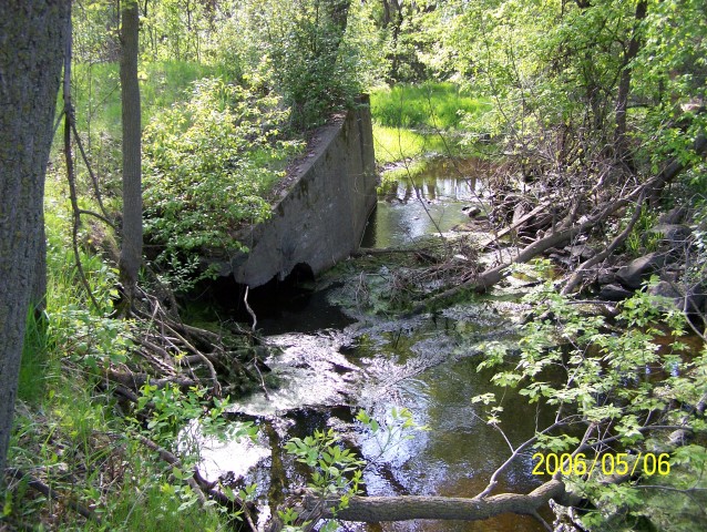 The remains of the footings of an even earlier bridge over Chub Creek are still visible at the end of the old grade.