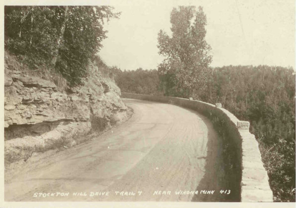 Looking back to the east on the first curve into the "Devil's Elbow". Note the lone tree, which is possibly the same one as seen in the previous photo. You can also see how the road is half concrete and half gravel. Note how the caption says "Trail 7", referring to Constitutional Route 7, the original designation for U.S. 14 in Minnesota.