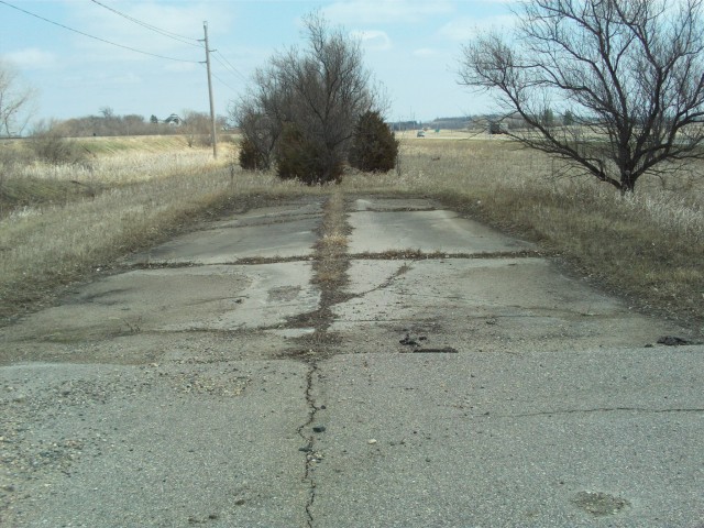 Another surviving piece of old concrete, on the east end of what is now shown as "Main Street" on the south side of Audubon along the north side of modern U.S. 10.
