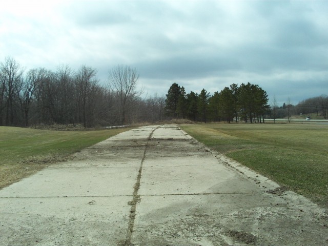 A short section of the old concrete pavement survives just west of Boyer Lake on the south side of the modern highway.