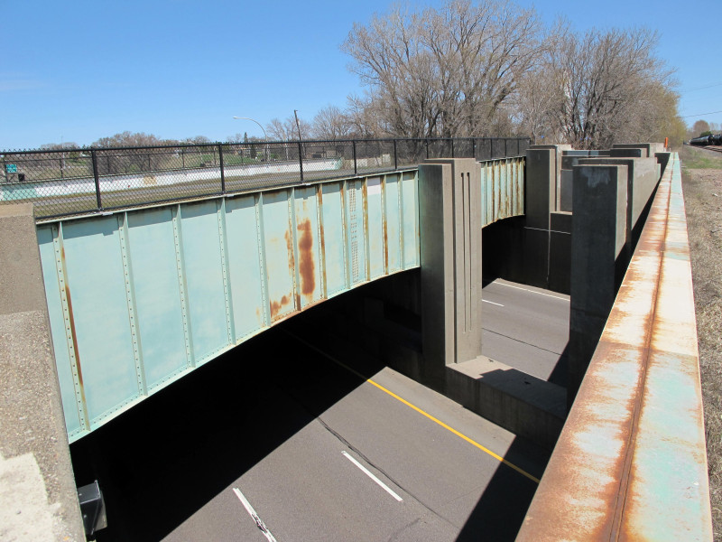 View between the old rail bridges over Highway 100, looking north.